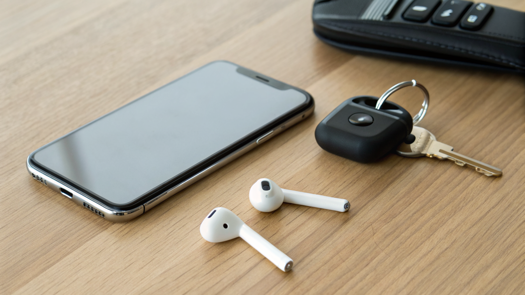 Смартфон, беспроводные наушники и ключи от автомобиля перед выбором устройства для звонков